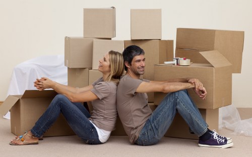 Professional movers carefully wrapping fragile belongings in a Yeading home